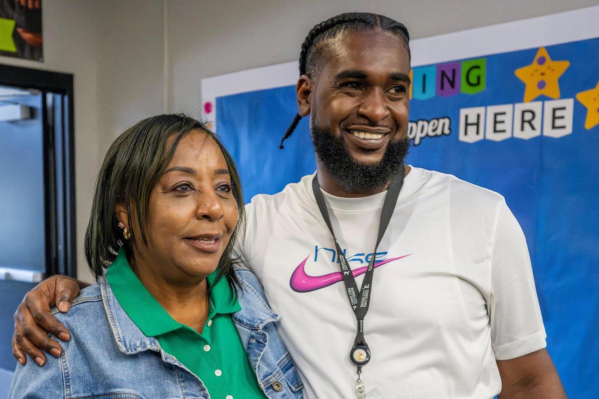 Kathyrene Hayes, assistant principal at Central Middle School, embraces Vincent Gunnels while speaking in a hallway on Monday, June 16, 2025, in Kansas City.