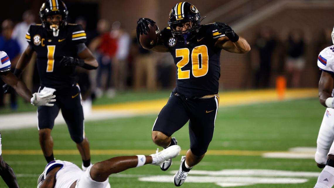 Missouri running back Cody Schrader (20) rushes for a first down during the third quarter of an NCAA football game against Louisiana Tech on Thursday, Sept. 1, 2022 in Columbia, Mo. (AP Photo/Colin E. Braley)