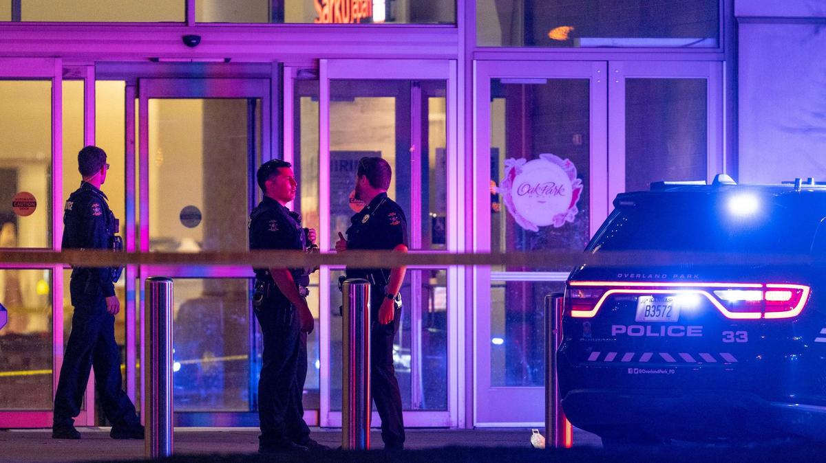 Police officers stand outside of the entrance to the Oak Park Mall food court after a gunshot was during an arrest of a suspected shoplifter on Sunday, in Overland Park. A 19-year-old Kansas City, Kansas, man has been charged with four felonies and five misdemeanors stemming from the incident.