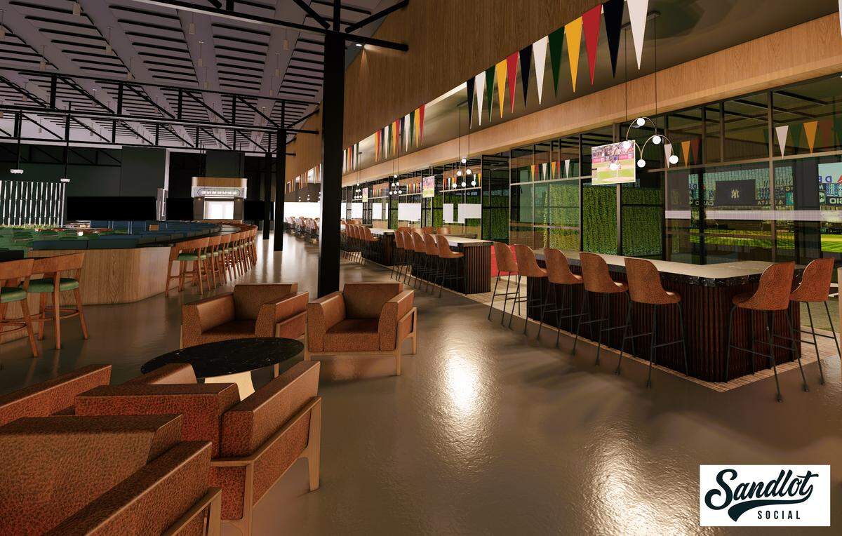 Batting cages line one part of the bar. A large screen sits on the other side.