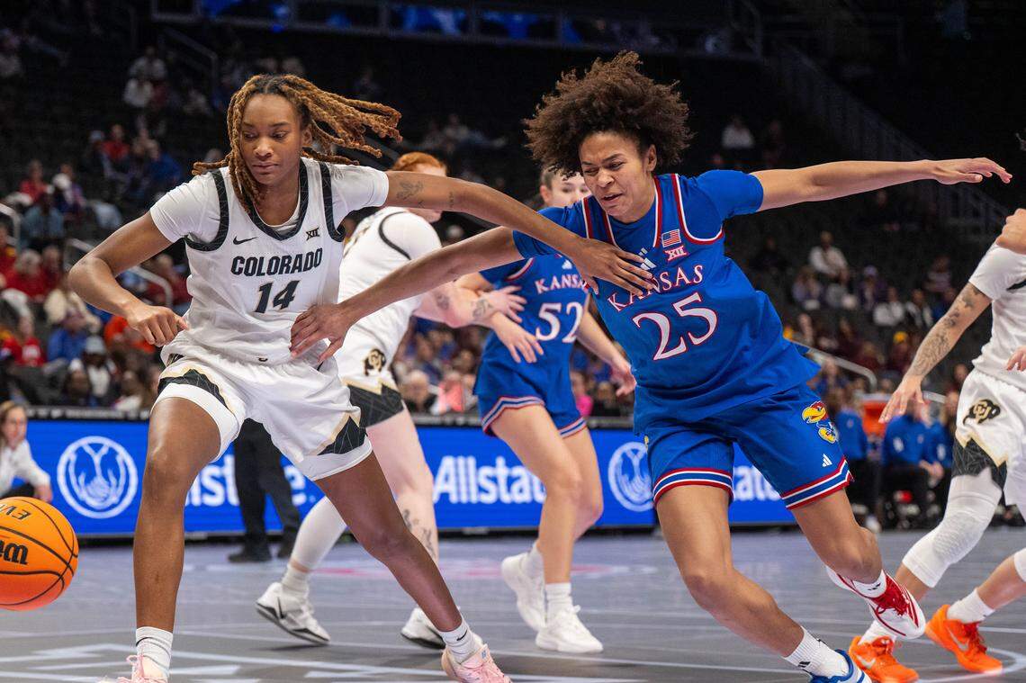 Kansas Jayhawks forward Jaliya Davis (25) fights for a loose ball against Colorado Buffaloes forward Jade Masogayo (14) in the first half of the Jayhawks second-round game of the Big 12 Women's Basketball Tournament on Thursday, March 5, 2026, at T-Mobile Center.