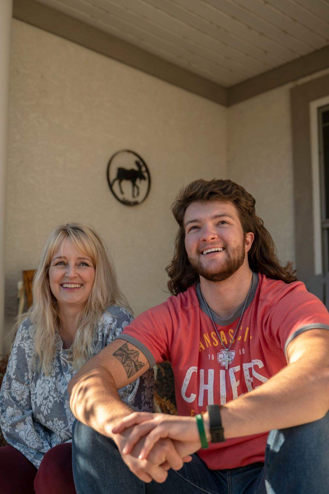 Rachelle Appleberry, left, and her son R.J. sit outside on their front porch at their home in Blue Springs. The family won a $4 million sex discrimination lawsuit against the local school district after R.J. was not allowed to use the boy’s bathroom.