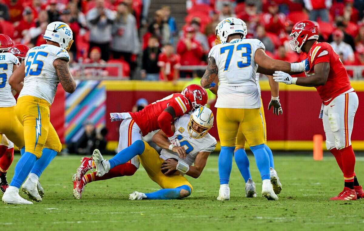 Kansas City Chiefs defensive back Chamarri Conner (27) sacks Los Angeles Chargers quarterback Justin Herbert (10) in the Kansas City Chiefs vs. Los Angeles Chargers NFL regular season game at Arrowhead Stadium in Kansas City on Oct. 18, 2026.