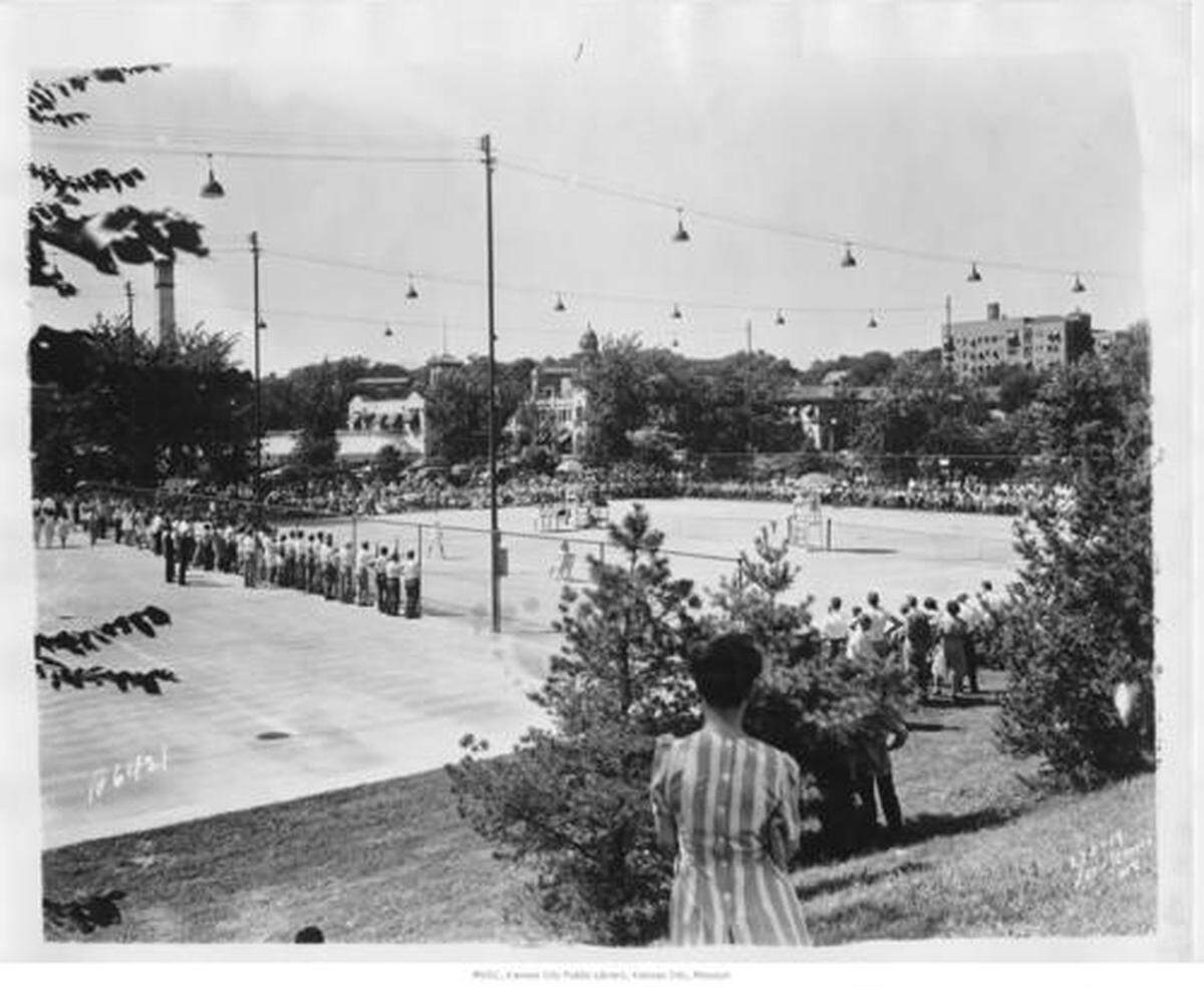 Distant view of a tennis match from east side of courts located between Main and Mill Creek Parkway in 1950.