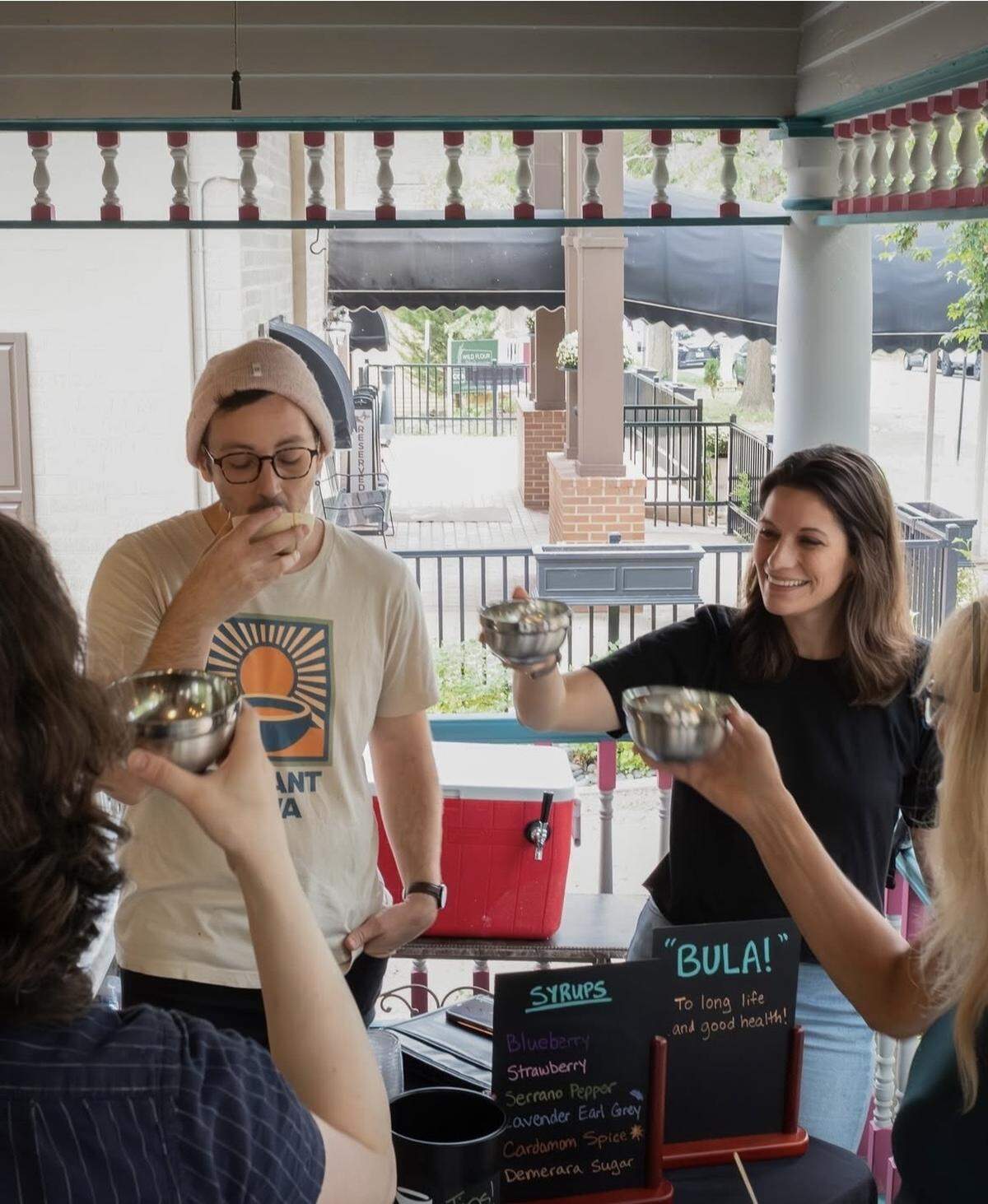 Wes Straight (left) drinks kava on the porch of the historic Parkville home where Deviant Kava will open.