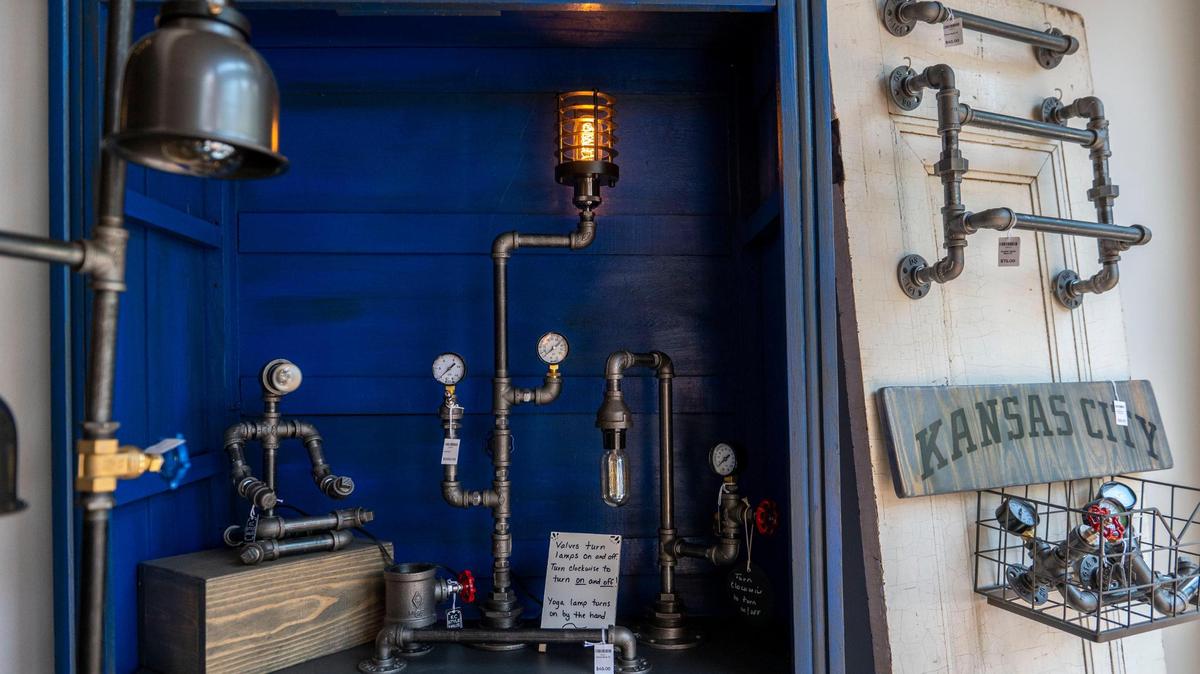 Lights made out of metal pipes are displayed on shelves for purchase at KC Style Haus.