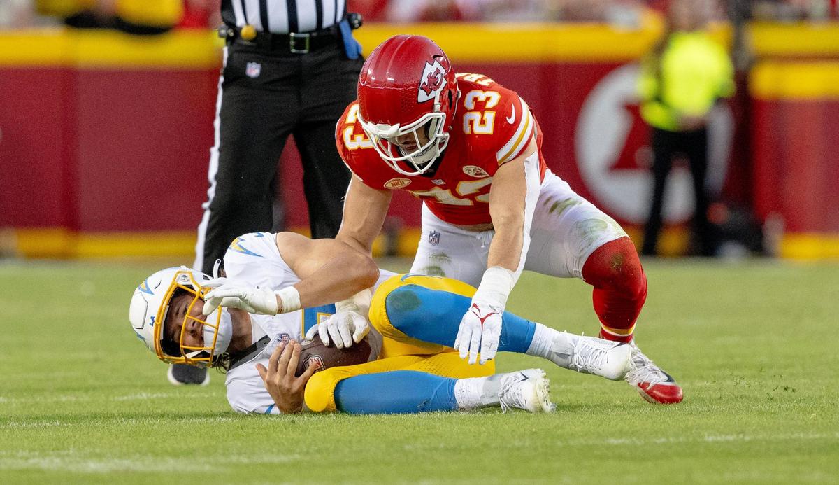 Chiefs linebacker Drue Tranquill (No. 23) sacks Los Angeles Chargers quarterback Justin Herbert during an Oct. 22 game at GEHA Field at Arrowhead Stadium.