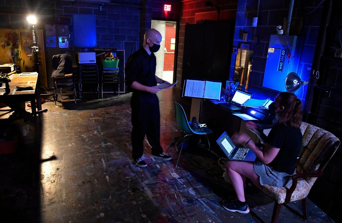 Assistant stage manager Dorian Allen, left, consults with stage manager Emily White-Winter, before a recent dress rehearsal for “Spider’s Web.”