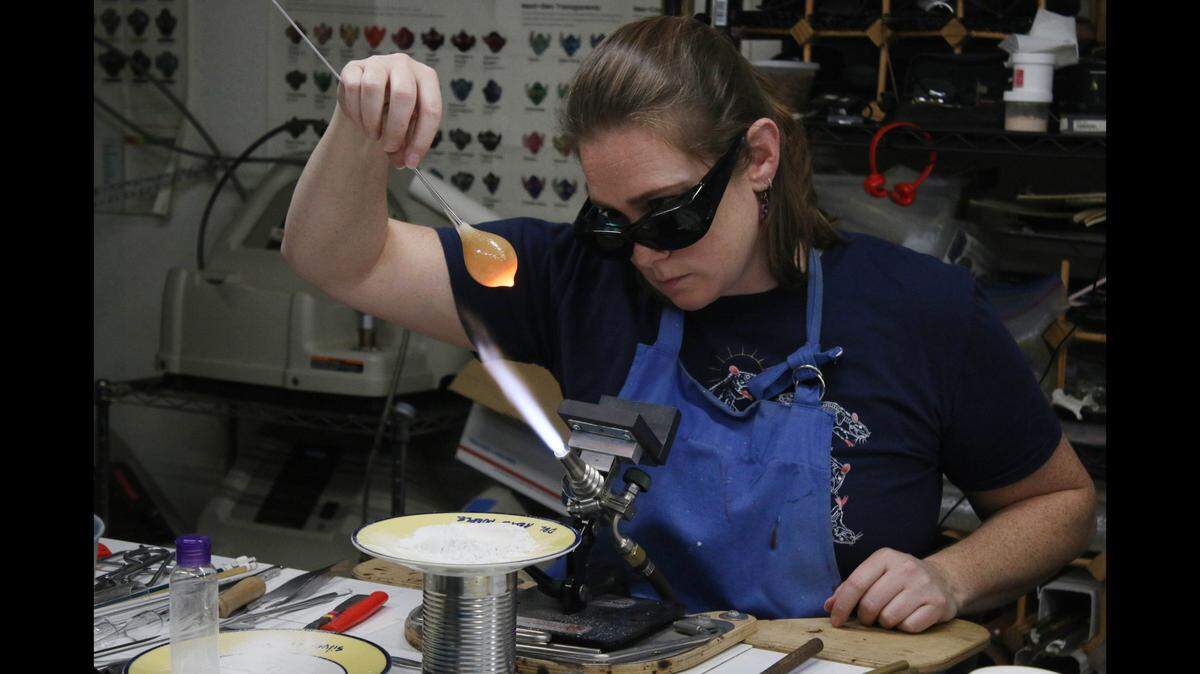 Laura Simone of Elmira, New York, makes a glass plum during at master class at Public Glassworks KC in Lenexa.