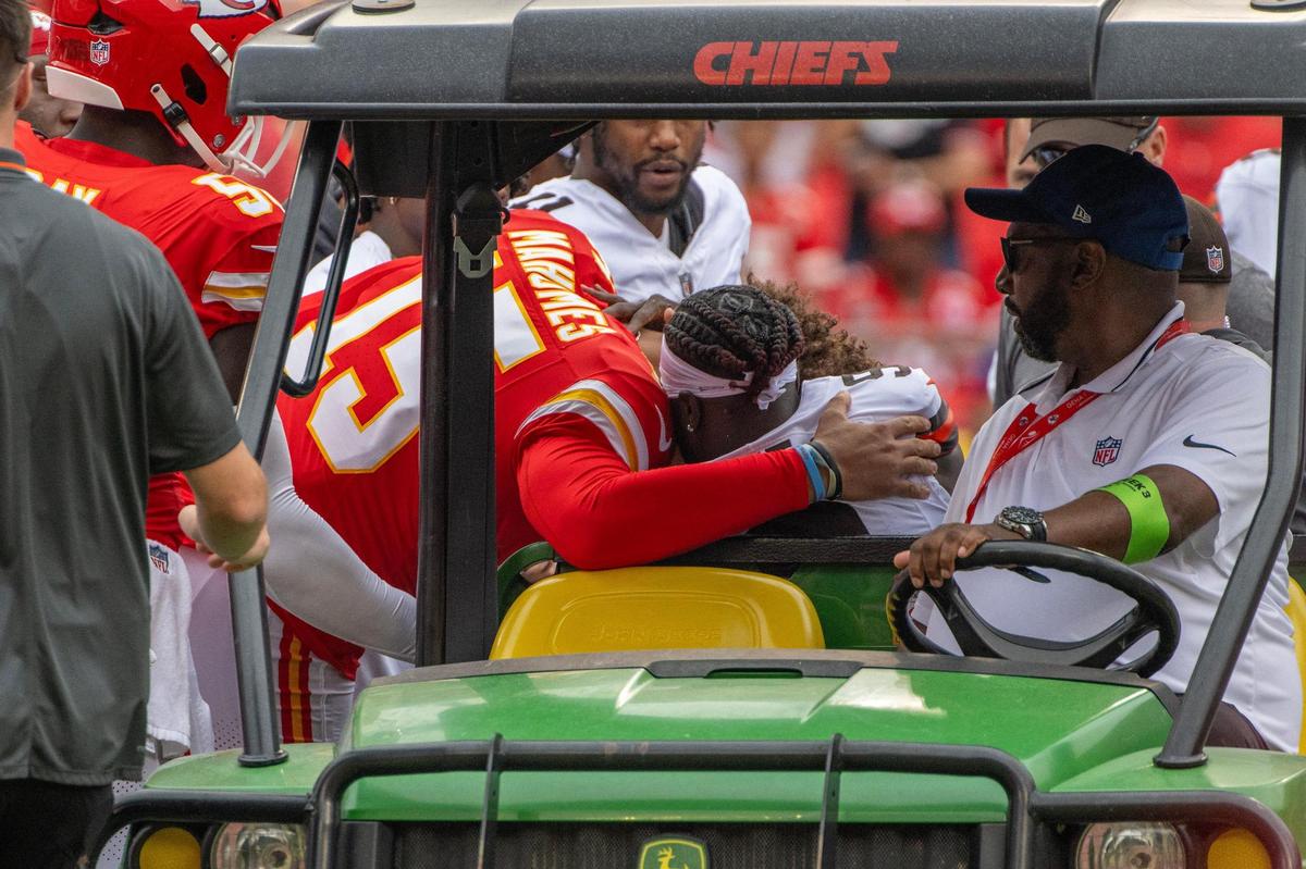 Kansas City Chiefs quarterback Patrick Mahomes (15) hugs Cleveland Browns wide receiver Jakeem Grant Sr. (9) after being hit during a preseason game at GEHA Field at Arrowhead Stadium on Saturday, Aug. 26, 2023, in Kansas City.