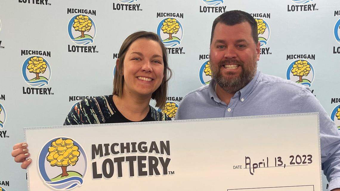 Nathan Brown and his girlfriend with their oversized check.