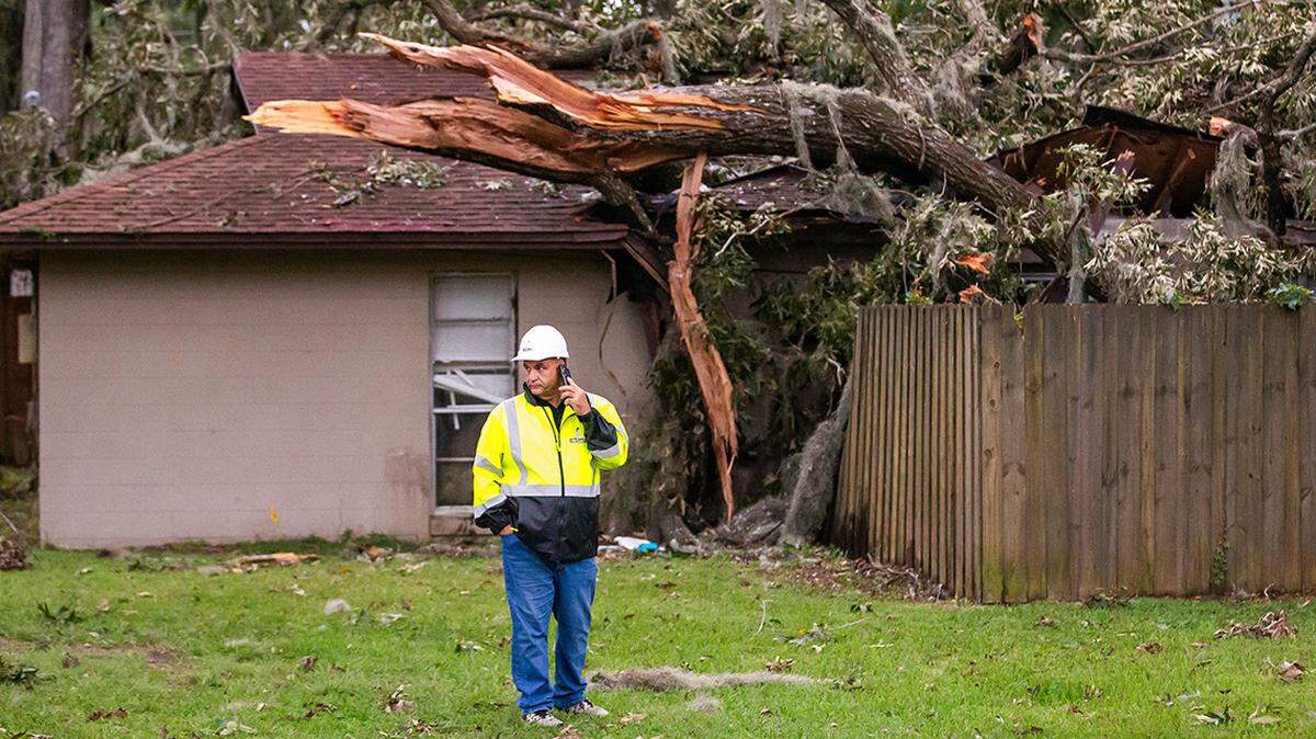 Director of Emergency Services David Knowles with 1-800-BoardUp, talks with crew members about when they could arrive Friday morning to start repairing the roof of a quadraplex at 1771 SE 40th Street Road in Ocala, where a tree fell on the building, displacing three families. People were also arriving at the special needs shelter at West Port High School Thursday afternoon September 26, 2024. Hurricane Helene is expected to make land fall in the big bend area of Florida late Thursday evening. [Doug Engle/Ocala Star Banner]2024