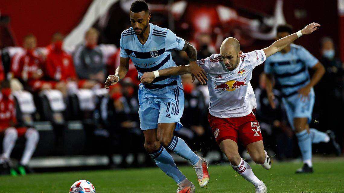 Sporting Kansas City forward Khiry Shelton (11) battles for the ball with New York Red Bulls defender Andrew Gutman (5) during an MLS soccer match, Saturday, April 17, 2021, in Harrison, N.J. (AP Photo/Adam Hunger)