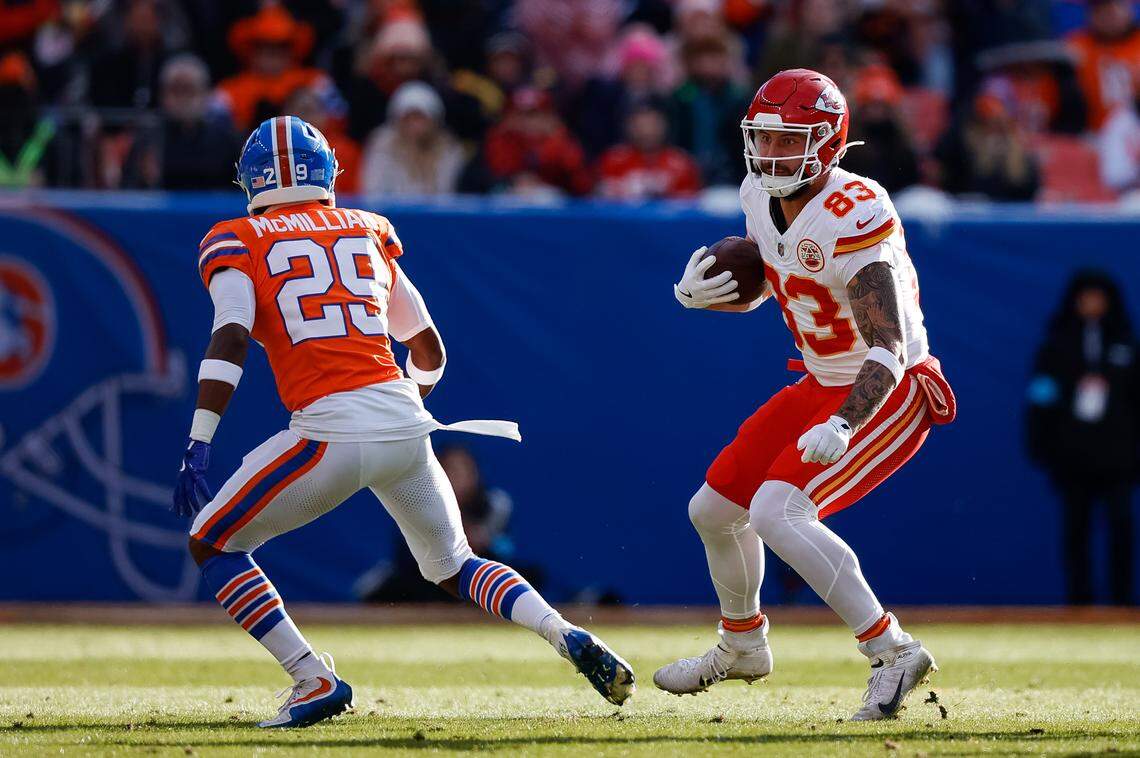 Kansas City Chiefs tight end Noah Gray, right, looks for a way around Broncos cornerback Ja’Quan McMillian during the teams’ NFL Week 18 game at Empower Field at Mile High in Denver on Sunday, Jan. 5, 2025.