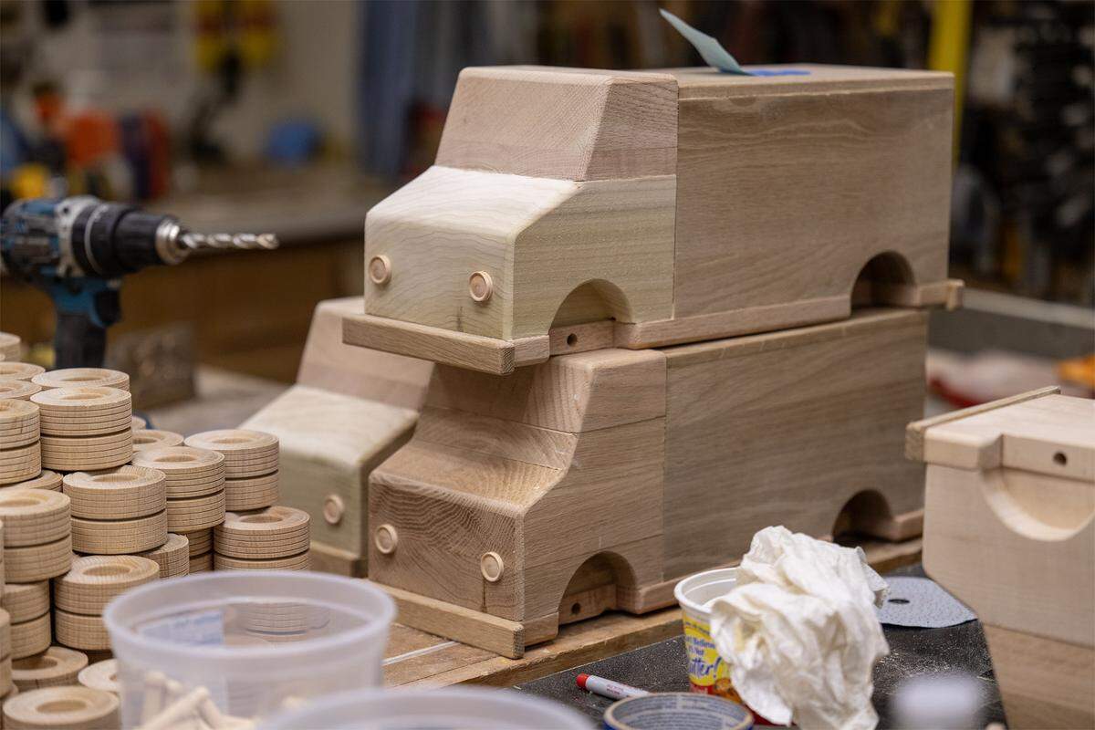 Donated wood scraps have been transformed into toy trucks by Jay Morris of JHM Woodworks and a team of volunteers who worked the trucks on Tuesday, Dec. 2, 2025 in Lawrence, Kansas. Morris will donate the 115 handmade trucks for kids in need through Toys for Tots program.