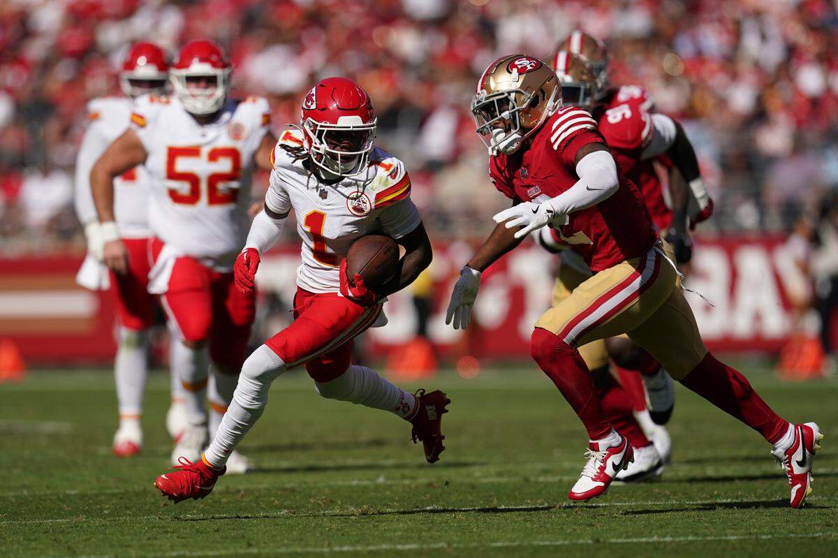 Kansas City Chiefs wide receiver Xavier Worthy (1) runs with the ball after making a catch in front of San Francisco 49ers cornerback Deommodore Lenoir (2) in the second quarter at Levi’s Stadium.