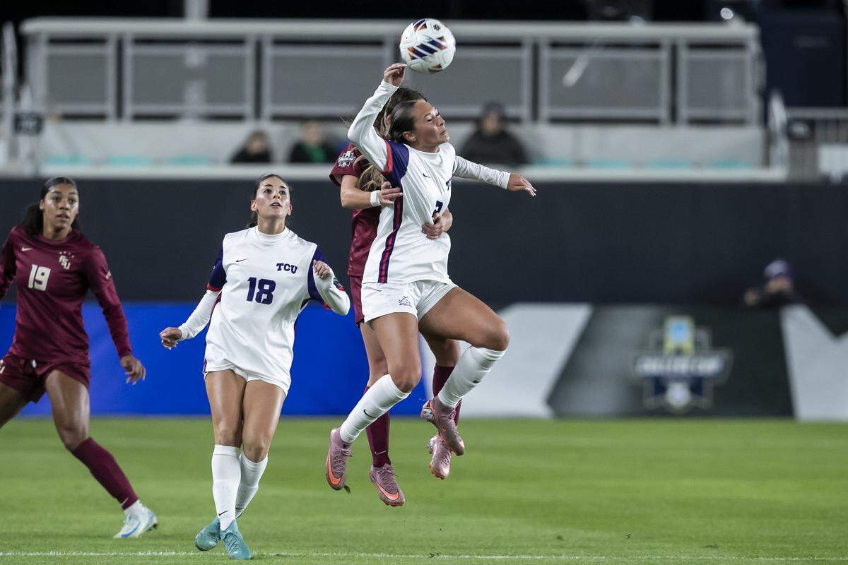 TCU midfielder Sydney Becerra (No. 2) heads the ball away from a Florida State defender during a College Cup NCAA Division I women's soccer semifinal match at CPKC Stadium in Kansas City, Missouri on Friday, Dec. 5, 2025. The Seminoles beat the Horned Frogs to advance.