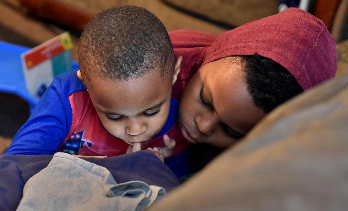 Tiffany Price’s kindergartner, Preston Harlmon, and fourth-grader, Phillip Harlmon take a break between lessons.