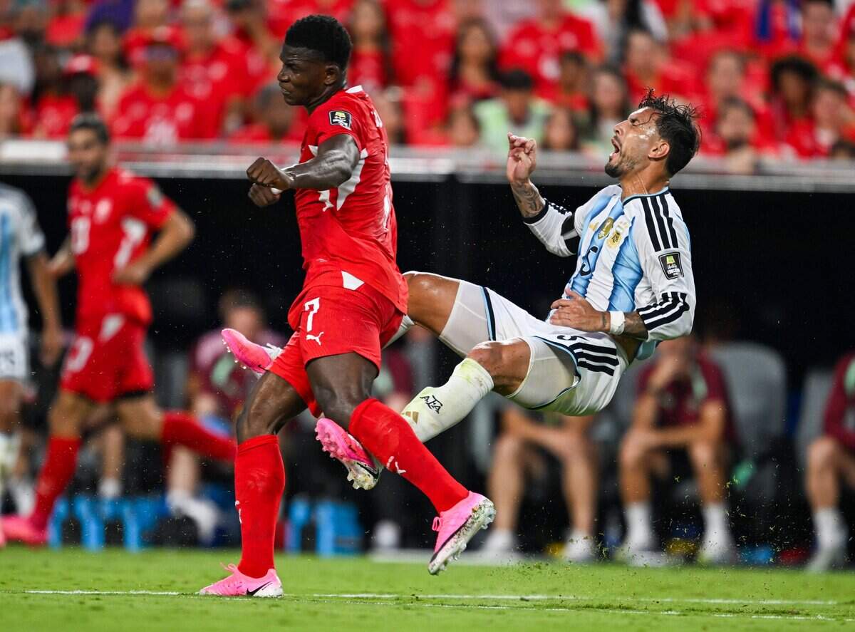 eSwitzerland forward Breel Embolo (7) catches the leg of Argentina midfielder Leandro Paredes (5). Embolo was called for a yellow card for the action in the Argentina vs. Switzerland 2026 World Cup Quarterfinal football match at Kansas City (Arrowhead) Stadium in Kansas City on Saturday, July 11, 2026.