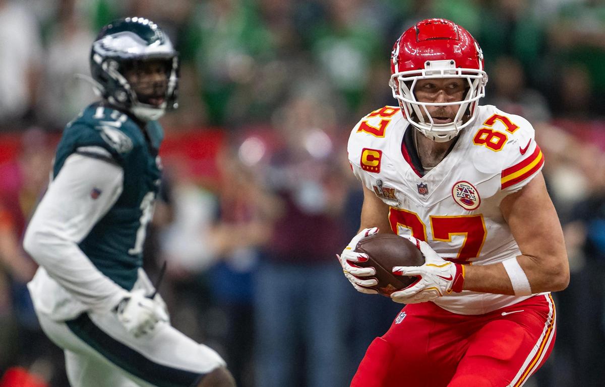 Kansas City Chiefs tight end Travis Kelce (87) runs with a pass as Philadelphia Eagles linebacker Josh Sweat (19) goes after him in the second half of Super Bowl LIX on Sunday, Feb. 9, 2025, in New Orleans.