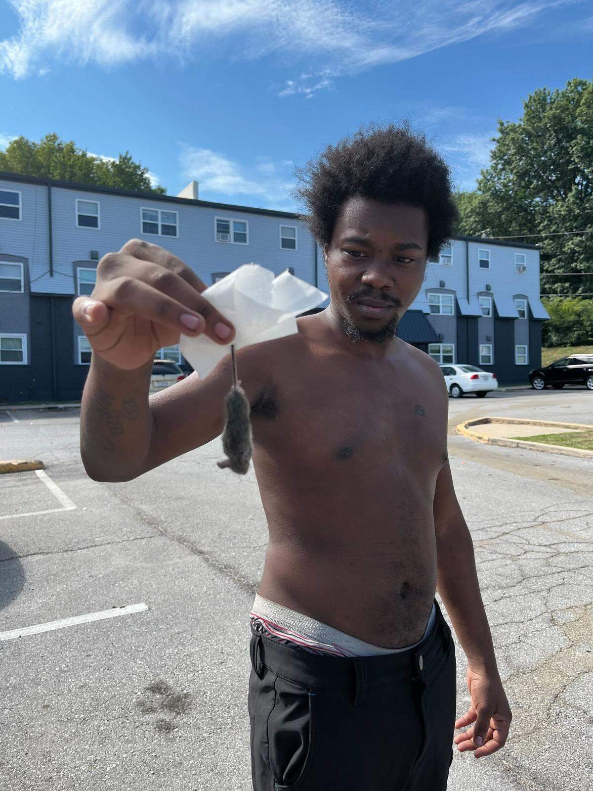 A resident of the Winner Place Apartments in Independence holds up a dead mouse found at his threshold. Until April, the complex was part of the portfolio of FTW Investments, a company run by Parker Webb of Kansas City.