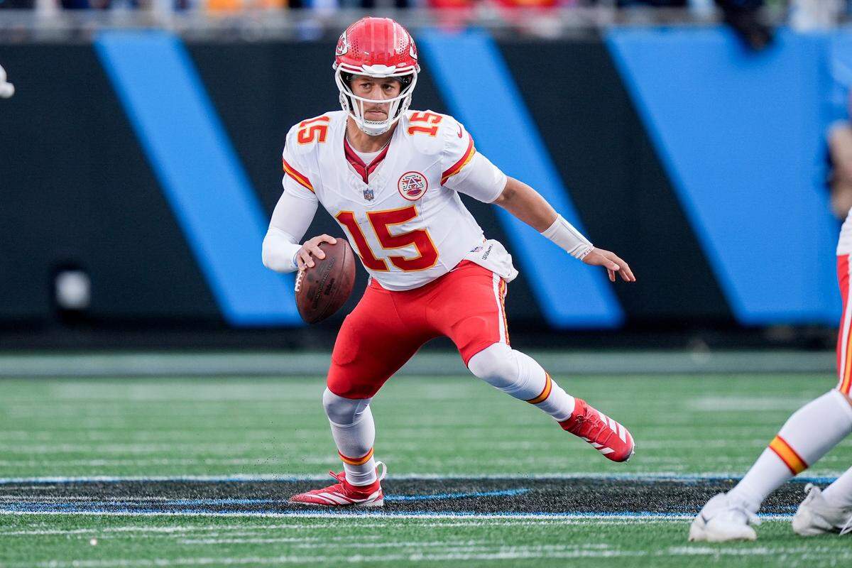 Kansas City Chiefs quarterback Patrick Mahomes (15) scrambles in the backfield against the Carolina Panthers during the second half at Bank of America Stadium.
