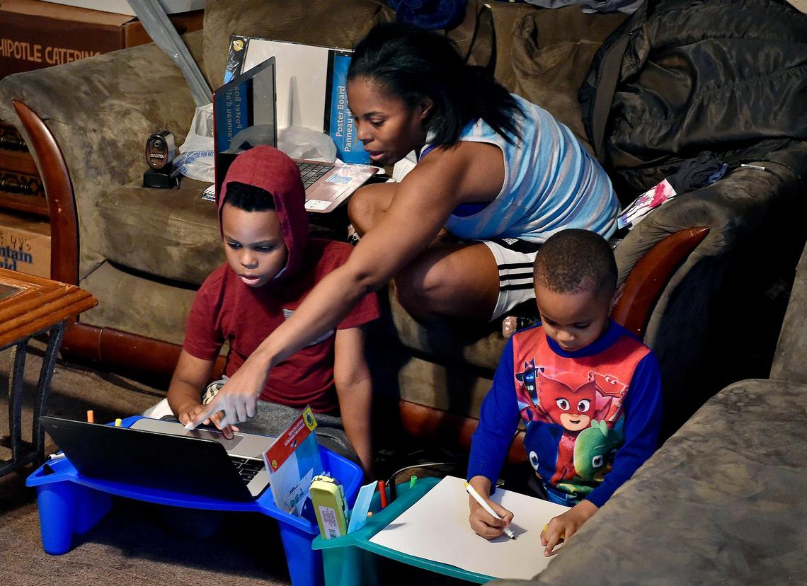 Tiffany Price and her fourth grade son, Phillip Harlmon, left, and kindergartner Preston Harlmon, have tackled remote learning from their Kansas City home due to the spread of COVID-19. Now she expects to continue the work through summer.
