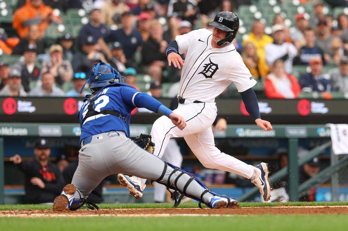 Dillon Dingler #13 of the Detroit Tigers tries to slide around the tag by Carter Jensen #22 of the Kansas City Royals in the fourth inning at Comerica Park on April 16, 2026 in Detroit, Michigan.