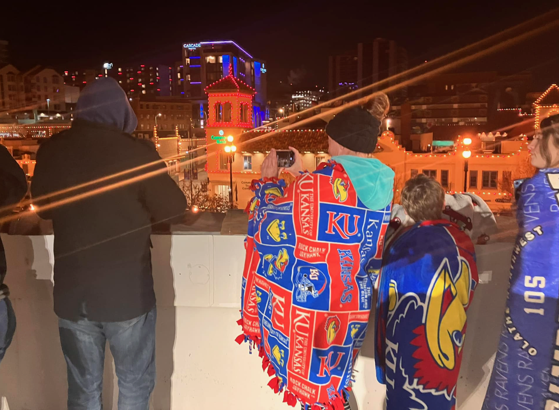 Jennifer West, middle, takes pictures of the Country Club Plaza lights during a test run on a Wednesday before Thanksgiving.
