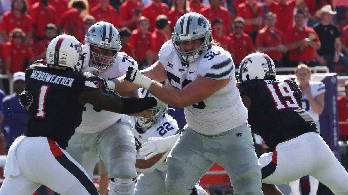 Kansas State Wildcats offensive tackle Cooper Beebe (50) blocks Texas Tech Red Raiders defensive linebacker Krishon Merriweather (1) in the first half at Jones AT&T Stadium on Oct. 23, 2021.