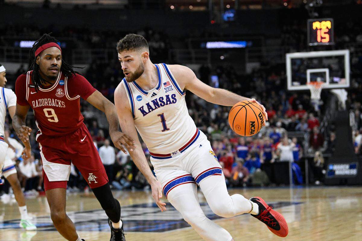 Kansas Jayhawks center Hunter Dickinson, right, dribbles against Arkansas Razorbacks forward Jonas Aidoo during a first-round NCAA Tournament men’s basketball game at Amica Mutual Pavilion in Providence, Rhode Island, on Thursday, March 20, 2025.