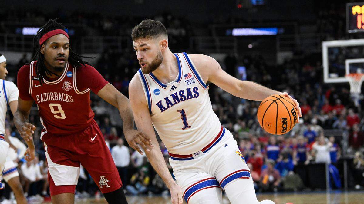 Kansas Jayhawks center Hunter Dickinson, right, dribbles against Arkansas Razorbacks forward Jonas Aidoo during a first-round NCAA Tournament men’s basketball game at Amica Mutual Pavilion in Providence, Rhode Island, on Thursday, March 20, 2025.