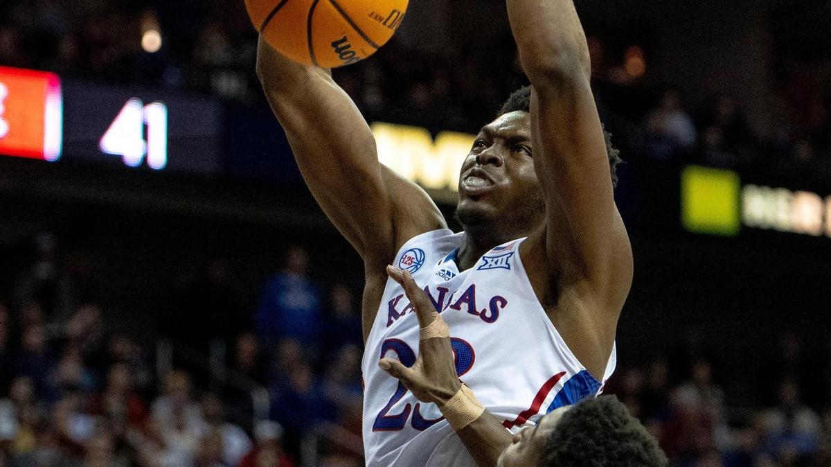 Kansas center Ernest Udeh Jr. (23) dunks the ball over Iowa State forward Hason Ward (24) during a semifinal game in the Big 12 Conference tournament Friday, March 10, 2023, in Kansas City.