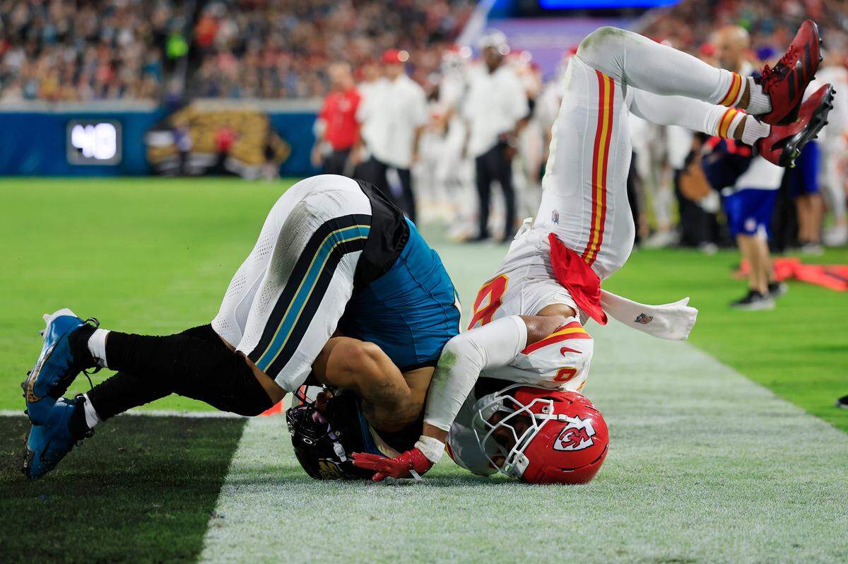 Jaguars wide receiver Parker Washington scores a touchdown as Kansas City Chiefs safety Bryan Cook (No. 6) is upended during an NFL game at EverBank Stadium in Jacksonville, Florida on Monday, Oct. 6, 2025.