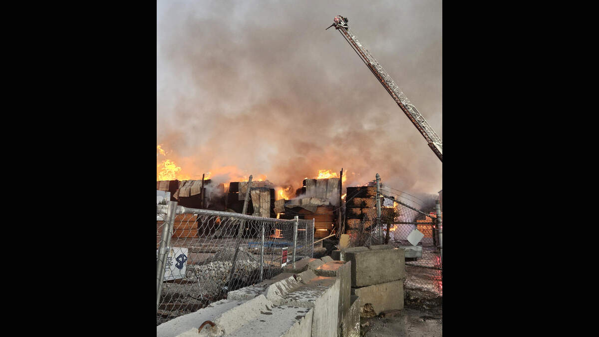 Firefighters battle a large fire Monday morning at the Central Missouri Reload Inc. lumberyard, 3900 E. 14th Terrace, east of downtown Kansas City. No injuries were reported.