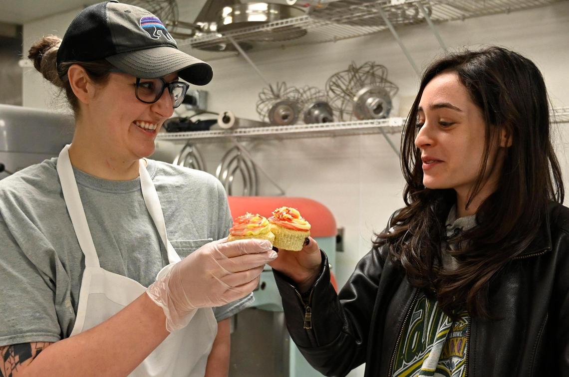 Michaela Sewalson, left, a trainer and social media manager at Emily Kate’s Bakery, shares a gluten-free cupcake toast with Kansas City Star reporter Matti Gellman.