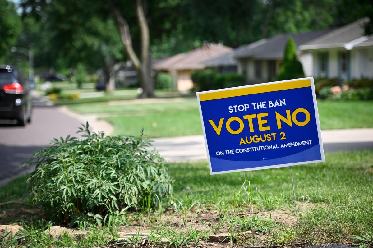 Signs encouraging people to vote “no” on the abortion amendment in the Aug. 2 election dot a neighborhood in Overland Park on Wednesday.