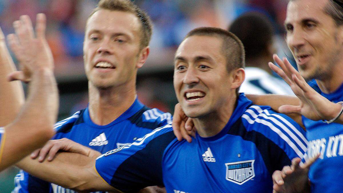 Davy Arnaud (center) celebrates a goal during a 2009 Kansas City Wizards game.
