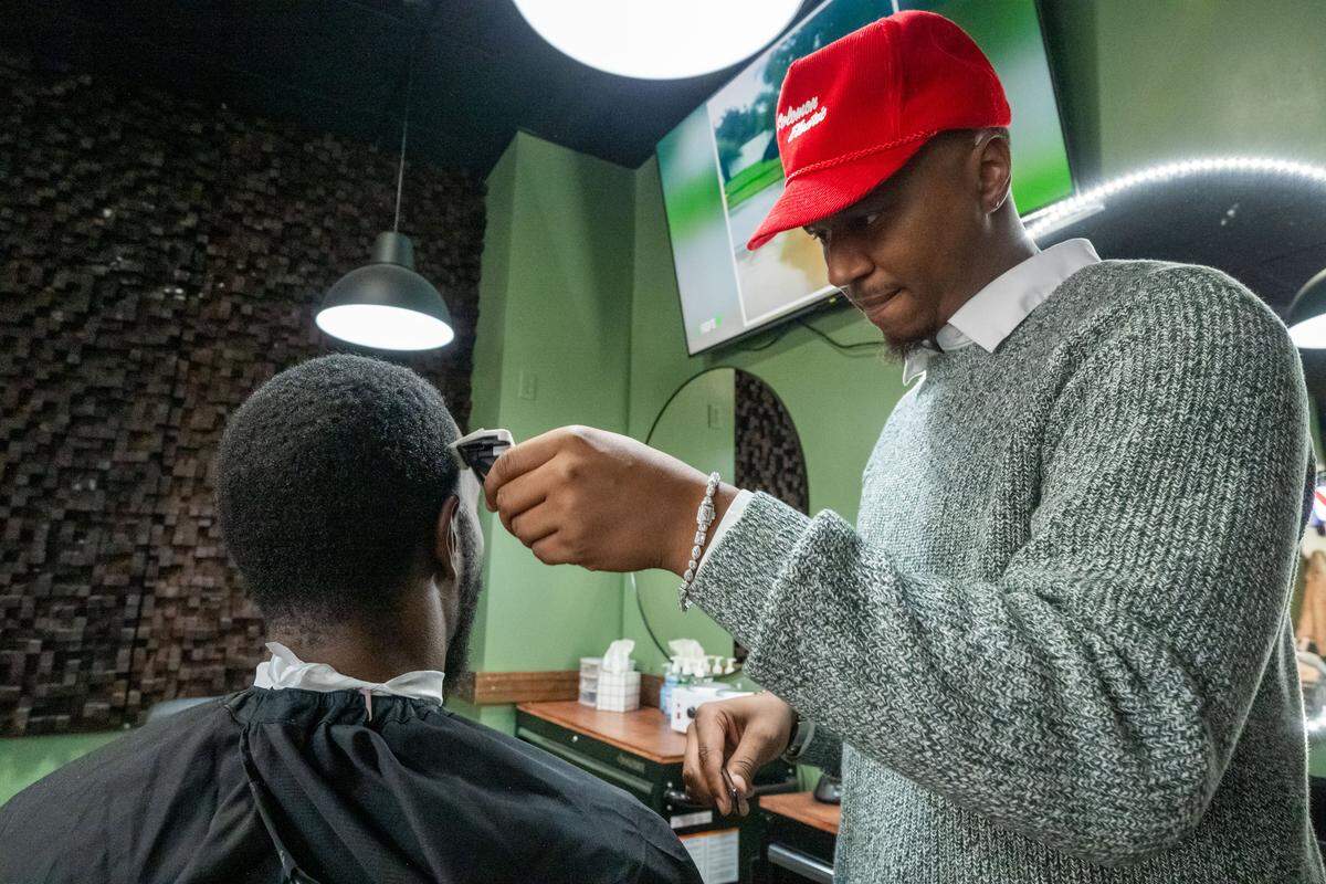 Jalen Toure Ford, co-owner of Klassic Guy Barber Lounge on 9th, focuses on a client's haircut, on Tuesday, February 3, 2026, in Kansas City. Customers can come for a shave or haircut and also grab a drink and relax in the lounge area.