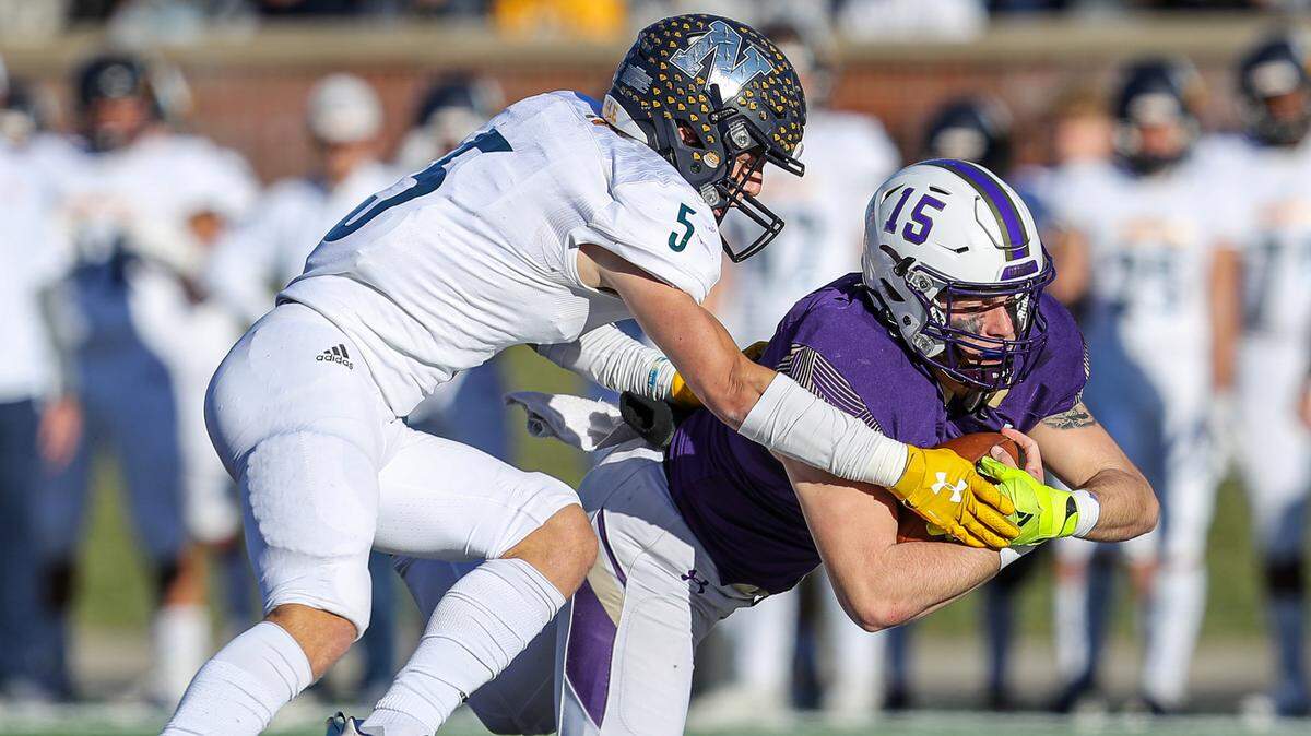 Christian Brothers College’s Patrick Heitert, right, runs for a first down before being tackled by Liberty North’s Eric Henkel during the third quarter of Saturday’s Class 6 Show Me Bowl game at Faurot Field.