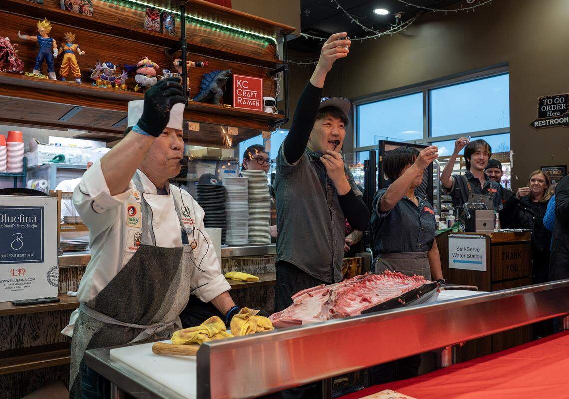 Chef Andy F. Matsuda, left, Kenichi Ota and Akiko Ota have a toast Kubota sake during a bluefin tuna cutting show at KC Craft Ramen on Monday, March 2, 2026, in Overland Park.