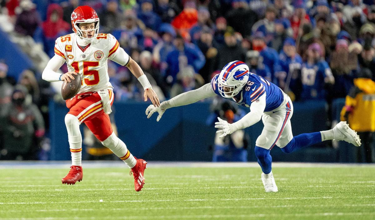 Kansas City Chiefs quarterback Patrick Mahomes (15) evades Buffalo Bills defensive end Leonard Floyd (56) during an AFC Divisional Round playoff game at Highmark Stadium on Sunday, Jan. 21, 2024, in Orchard Park, New York.