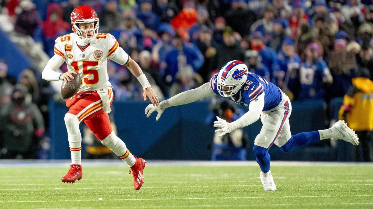 Kansas City Chiefs quarterback Patrick Mahomes (15) evades Buffalo Bills defensive end Leonard Floyd (56) during an AFC Divisional Round playoff game at Highmark Stadium on Sunday, Jan. 21, 2024, in Orchard Park, New York.