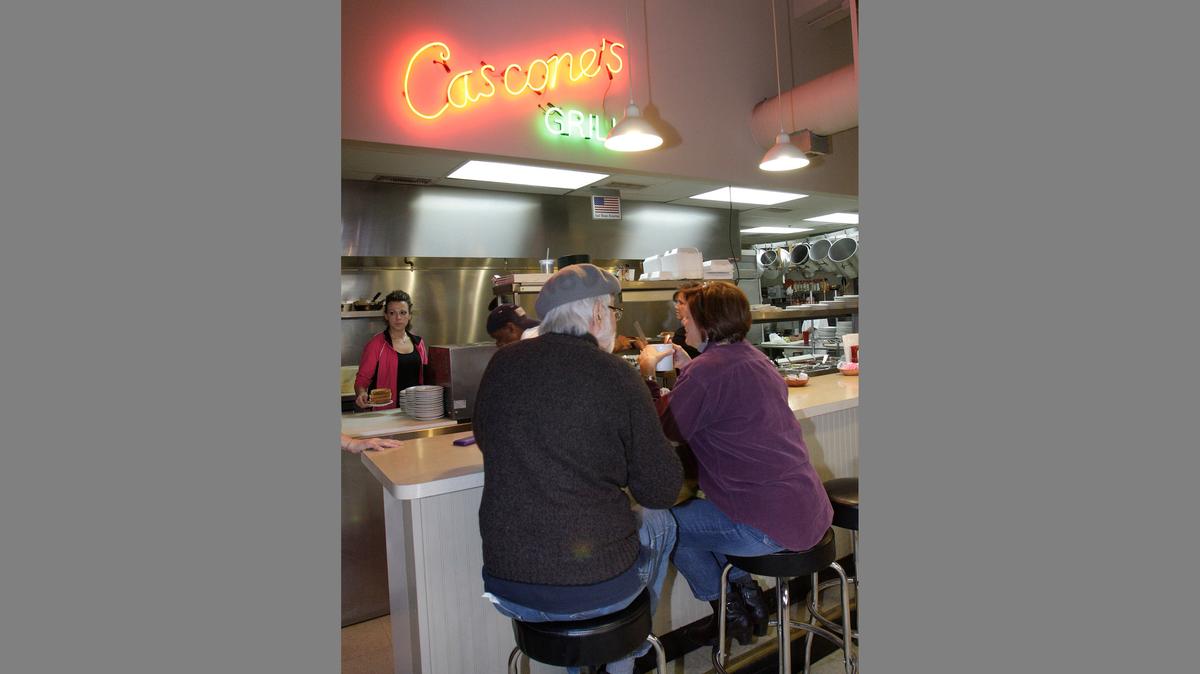 In this 2011 file photo, diners sit at the counter at Cascone’s Grill 17 E. 5th Street in the City Market area, where they can chat with the staff and watch their breakfast being cooked. The restaurant has announced it is closing its River Market location.