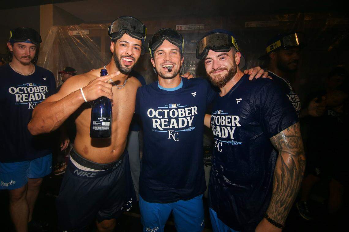 Kansas City Royals left fielder MJ Melendez (1) and second baseman Adam Frazier (26) and center fielder Kyle Isbel (28) celebrate after clinching a wild card playoff birth after a game against the Atlanta Braves at Truist Park.