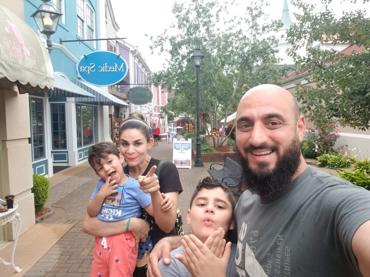 Saif takes a picture with Noora, Yazin and Nezar. Saif said one of his favorite memories of Noora is when she smiles while helping their children. She did everything with joy, he said.