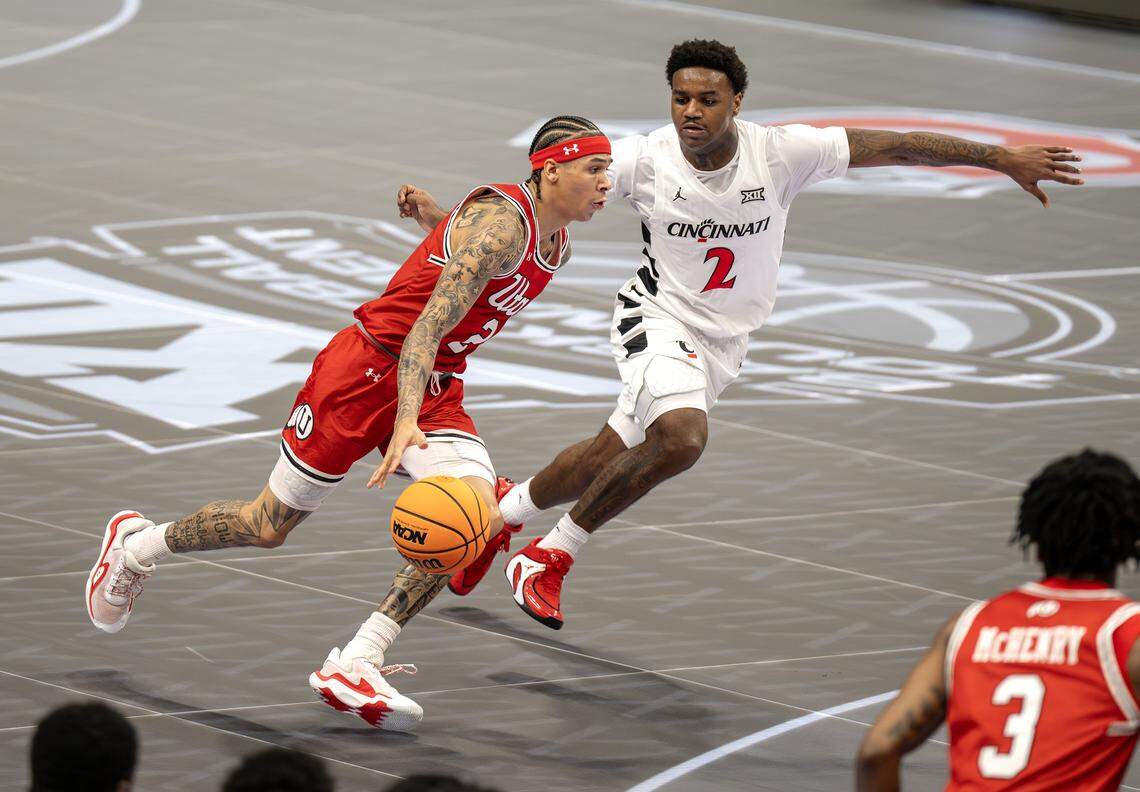 Utah Utes guard Terrence Brown (2) dibbles the ball up the court against Cincinnati Bearcats guard Jizzle James (2)  during the first half of the Big 12 Men's Basketball Tournament at T-Mobile Center on Tuesday, March 10, 2026, in Kansas City.