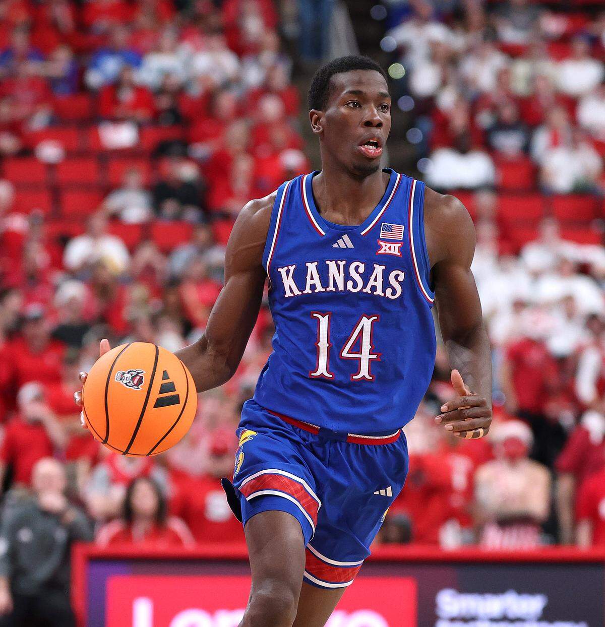Melvin Council Jr. #14 of the Kansas Jayhawks moves the ball against the NC State Wolfpack during the second half of the game at Lenovo Center on December 13, 2025 in Raleigh, North Carolina.