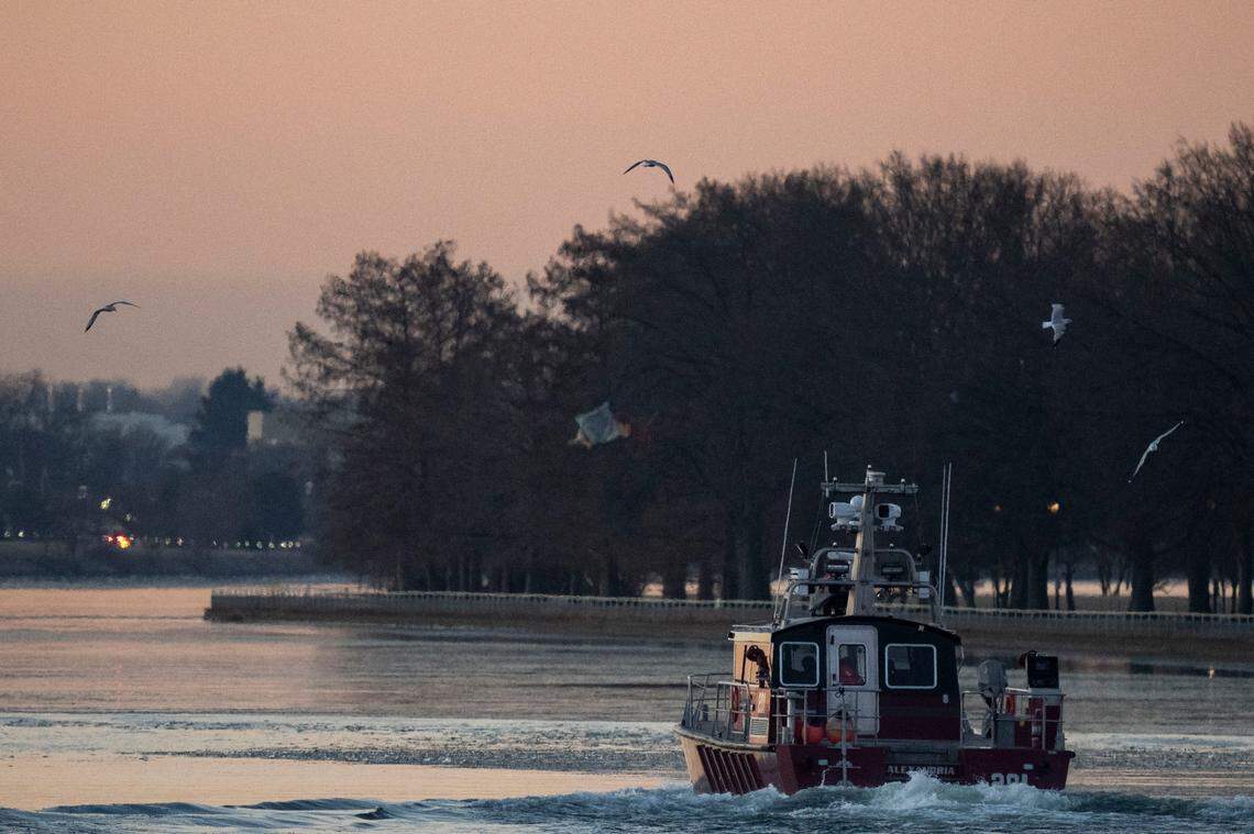 An Alexandria Fire Department crew departs the Metropolitan Police Department Harbor Patrol facility Thursday on its way to the site of the crash between an American Airlines passenger jet and an Army Black Hawk helicopter near Ronald Reagan Washington National Airport.
