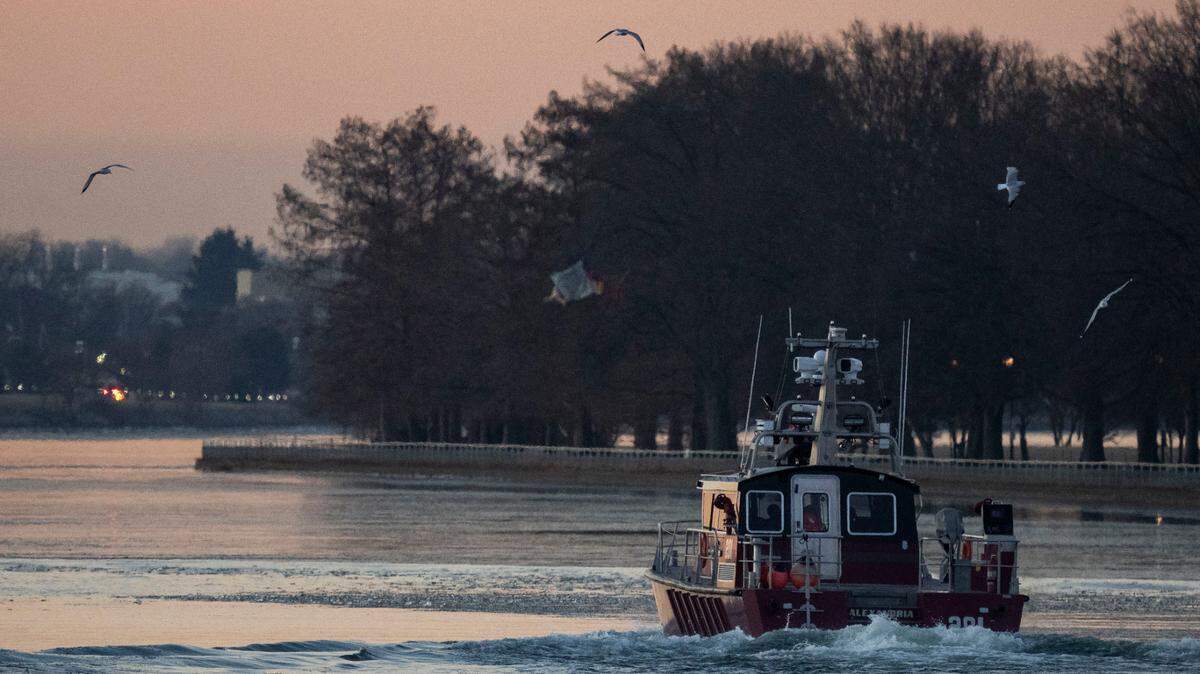 An Alexandria Fire Department crew departs the Metropolitan Police Department Harbor Patrol facility Thursday on its way to the site of the crash between an American Airlines passenger jet and an Army Black Hawk helicopter near Ronald Reagan Washington National Airport.